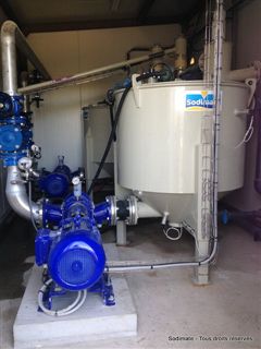 Lime feeder feeding into sludge mixing tank with sludge transfer pump